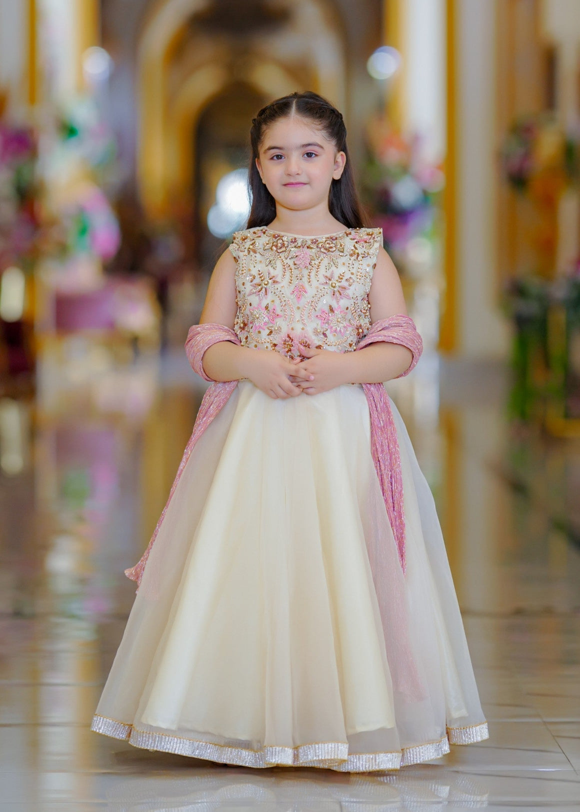 Seerat EZZA girls off-white tissue choli and silk lehenga set
Detailed hand-crafted Adda work on Seerat EZZA tissue choli
Full silhouette of Seerat EZZA multi-layered silk lehenga